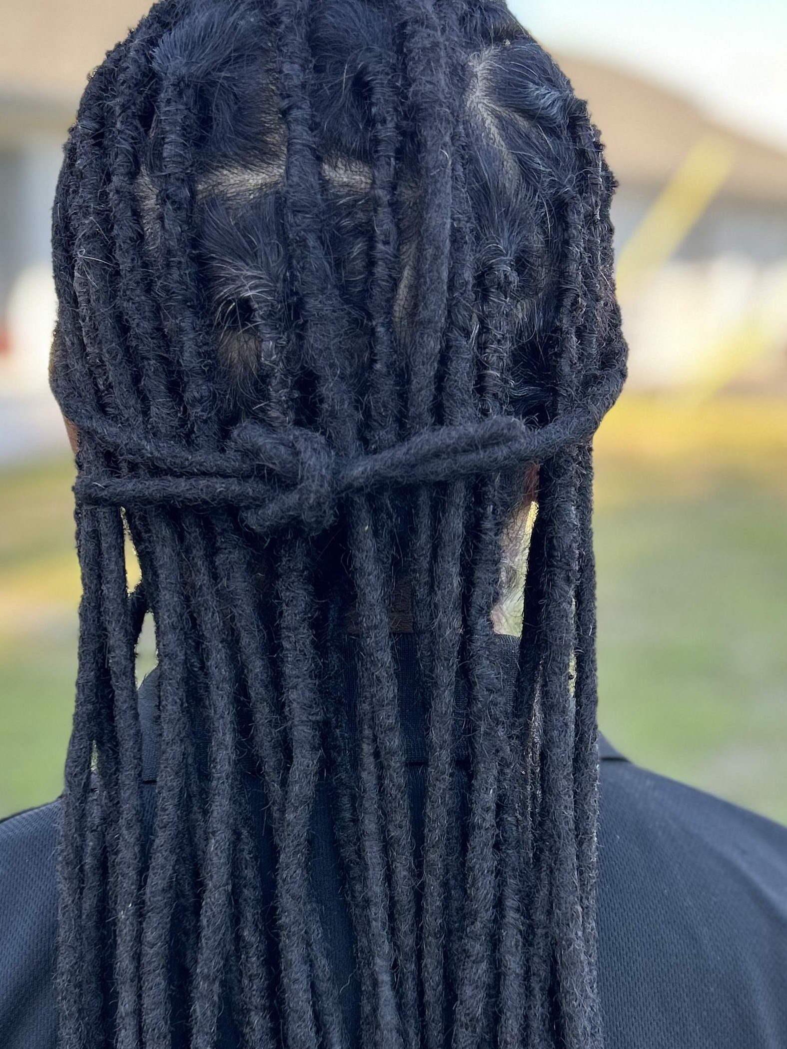 A full head of dreadlocks with human hair extensions.