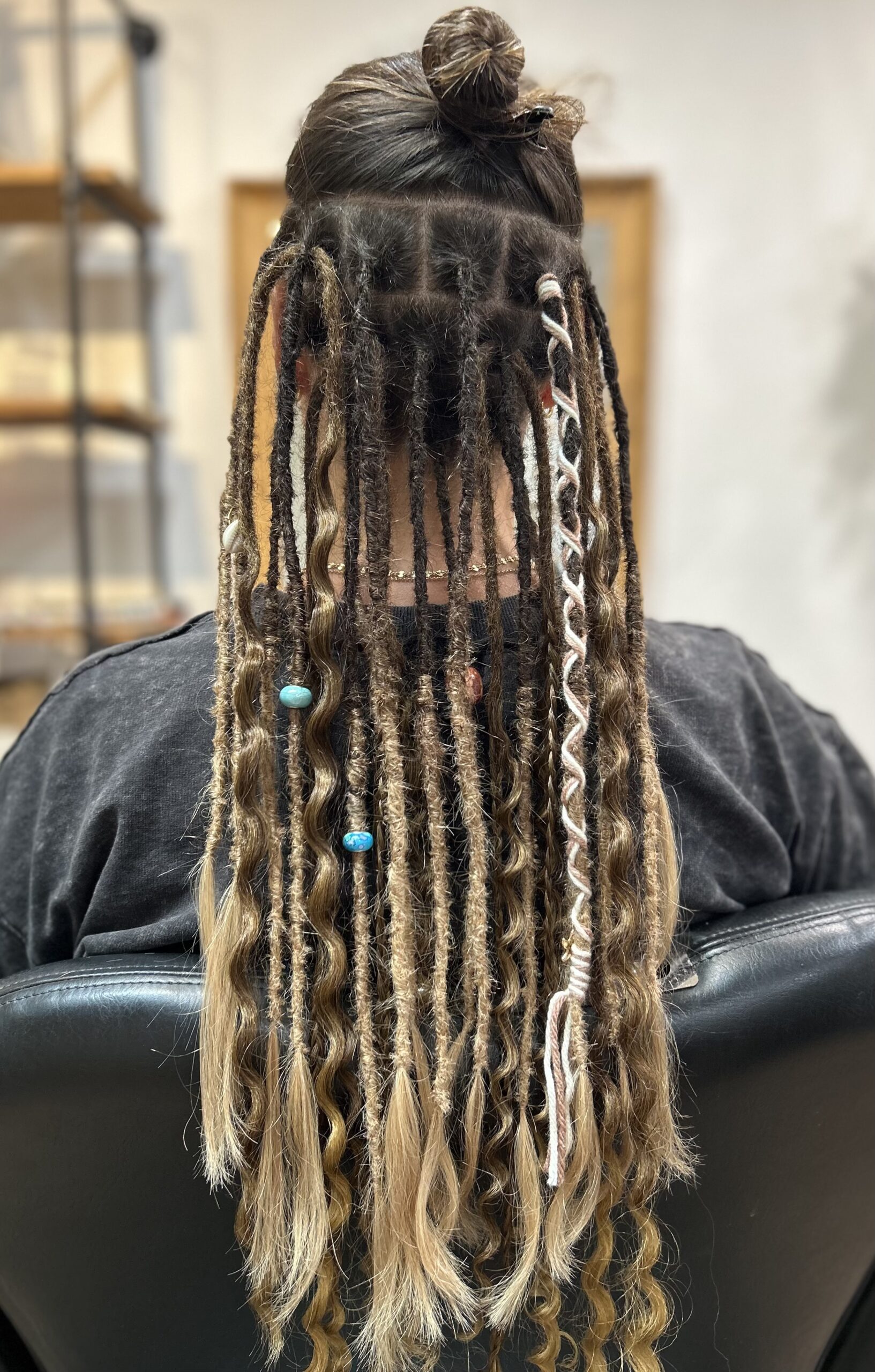 Dreadlocks extended with human hair and synthetic extensions.